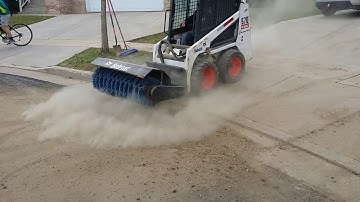 Bobcat s70 with 48" angle broom sweeping driveway