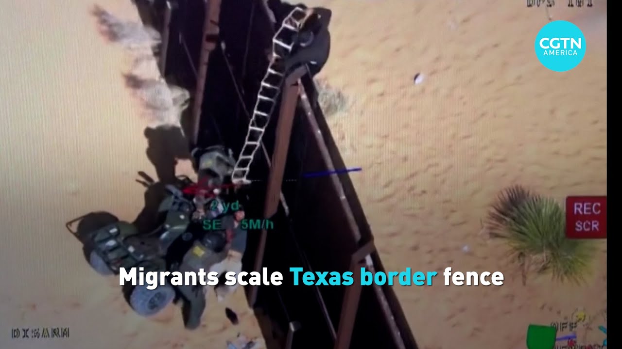 Migrants scale U.S. border fence - YouTube