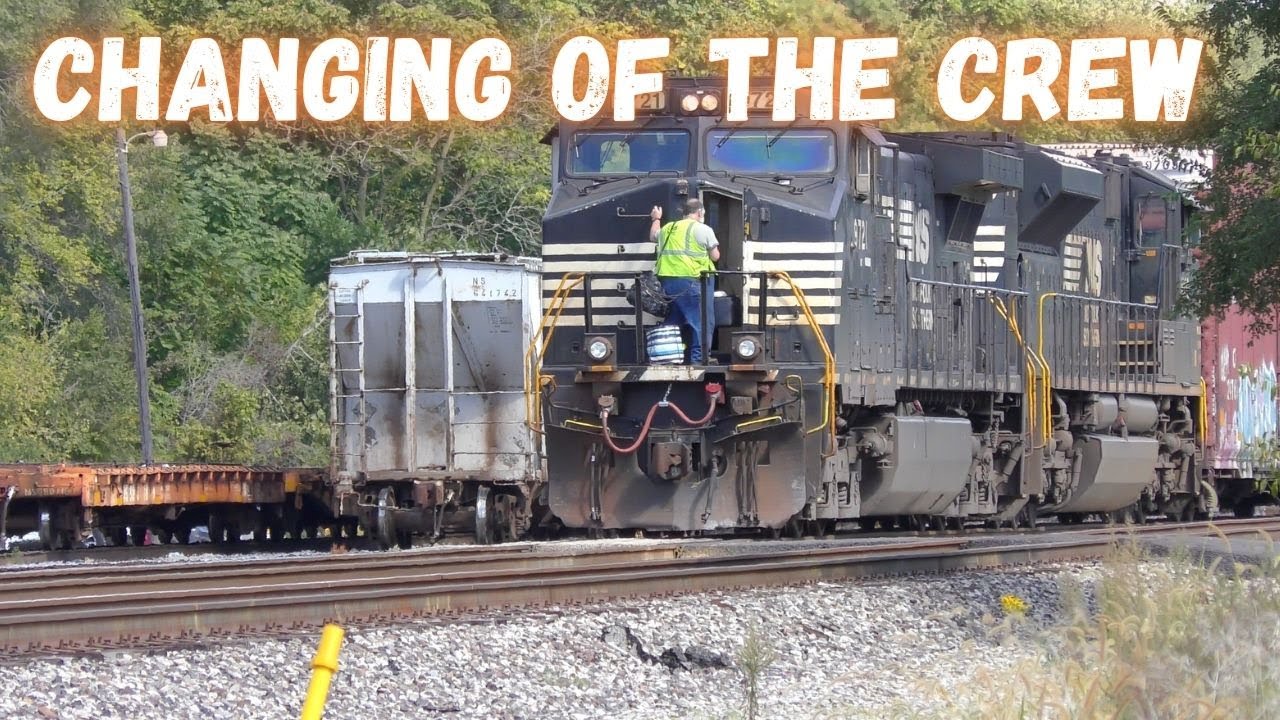 An auto-rack train with lots of old box cars gets a fresh crew on the ...