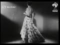 Models show latest Christian Dior evening gowns (1948)