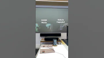 XGIMI MoGo Vs Nebula Capsule 3 Mini Projector Film In Store With All Lighting On 
