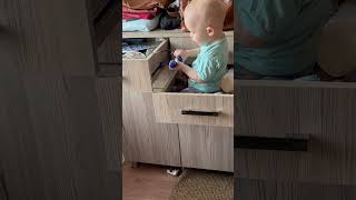 Playful Child Having Fun While Sitting Inside Dresser’s Drawer