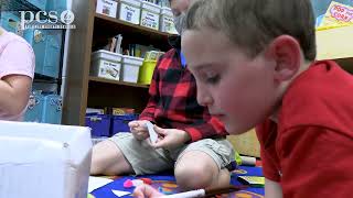 First and second grade students use STEM concepts to build gingerbread houses