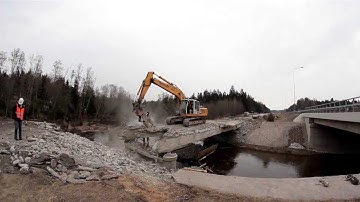 540 Bulldozer destroying a bridge backhoe working on the damaged bridged