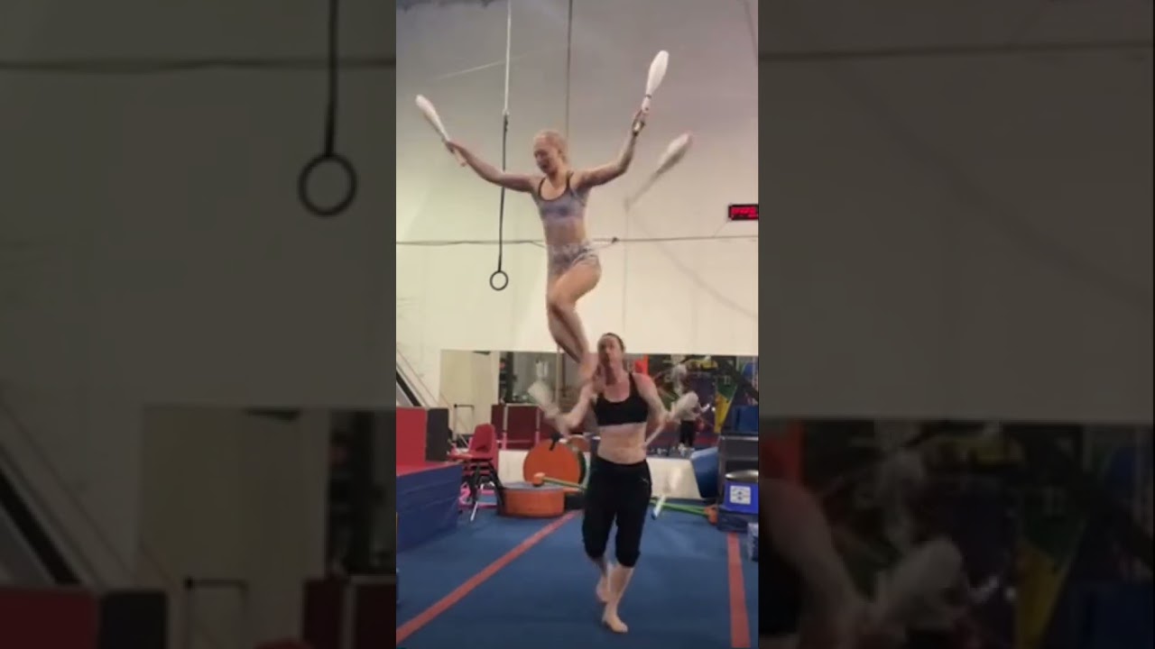 KATCH ZED & ATOM JANE juggling clubs in a two high