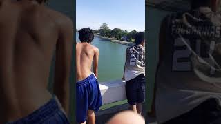 Young boys jump into the river