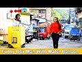 Funny box man with water balloon prank  throwing ice water balloons at people  prakash peswani 