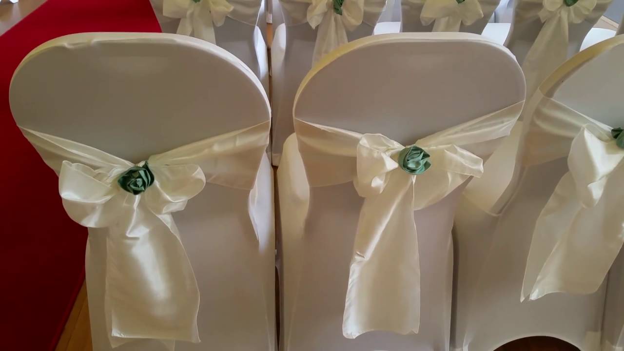 Wedding Chair Covers at the Normanby Hall White Lycra, Ivory Taffeta and Emerald Green Satin Roses