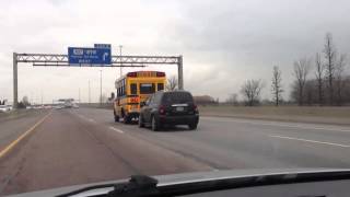 School bus towing car