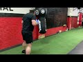 Boxing class focusing on heavy bag drills