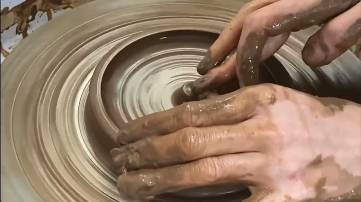 Throwing a black someware incense holder on the pottery wheel