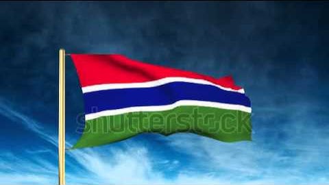 Gambia flag slider style. Waving in the wind with cloud background animation Stock video by