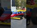 A Formula 3 Car Driving In A Public Park mp3