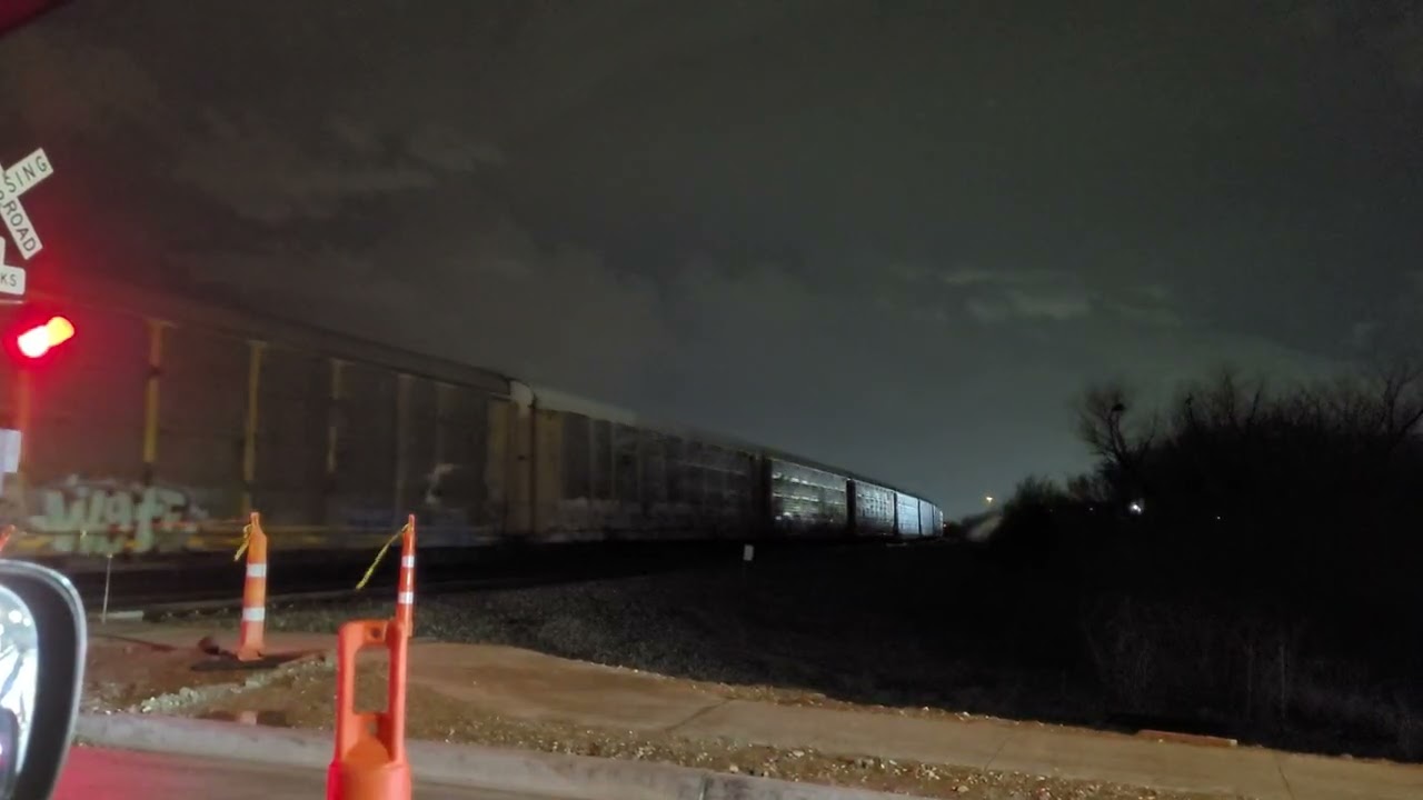 Lone UP Locomotive Moving Autoracks on a Stormy Night