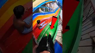 The boy got stuck in the slide because of a mistake.