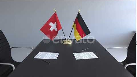 Flags of Switzerland and Germany and Papers on the Table | Motion Graphics - Envato elements