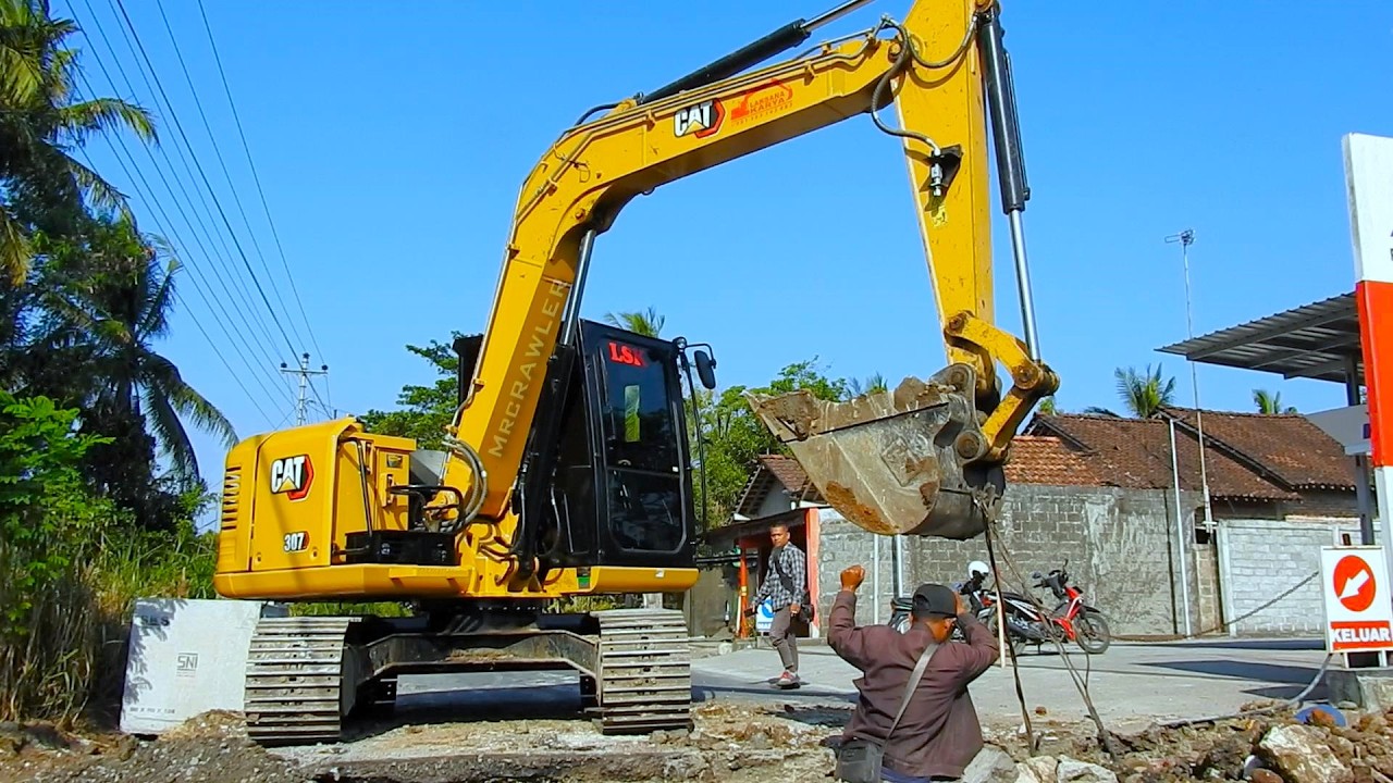 CAT 307 Excavator Battles Drainage Construction Challenge