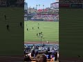 Fan runs on field at Dodger Stadium, stopped by ball girl