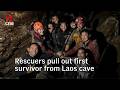 Rescuers evacuate the first of 5 villagers found trapped in a cave in Laos