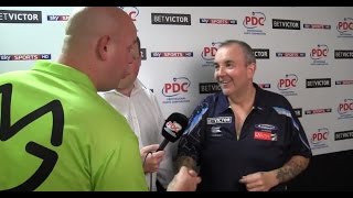 Michael van gerwen interrupts phil taylor's post-match interview to
congratulate him after a 16-8 win for taylor in the 2014 betvictor
world matchplay final....