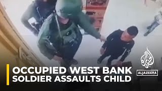 Israeli soldiers assault a Palestinian child in a shop in Hebron