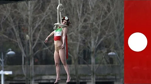 Topless Femen activist stages mock hanging protesting Rouhani visit