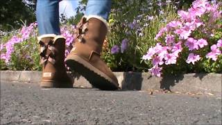 My sexy new chestnut Ugg Bailey Bow II near flowers