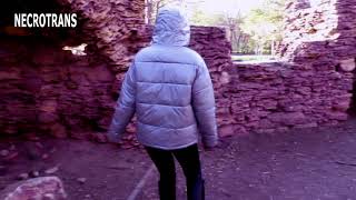 Spring walks Nekro-Neko in black leather leggings, pink oversized down jacket + full face respirator
