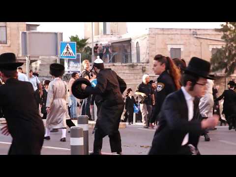 Women in bras confront Ultra-Orthodox Jews protesting against Eurovision