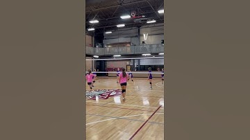 Hard Hit Girls Volleyball overhand serve over the net