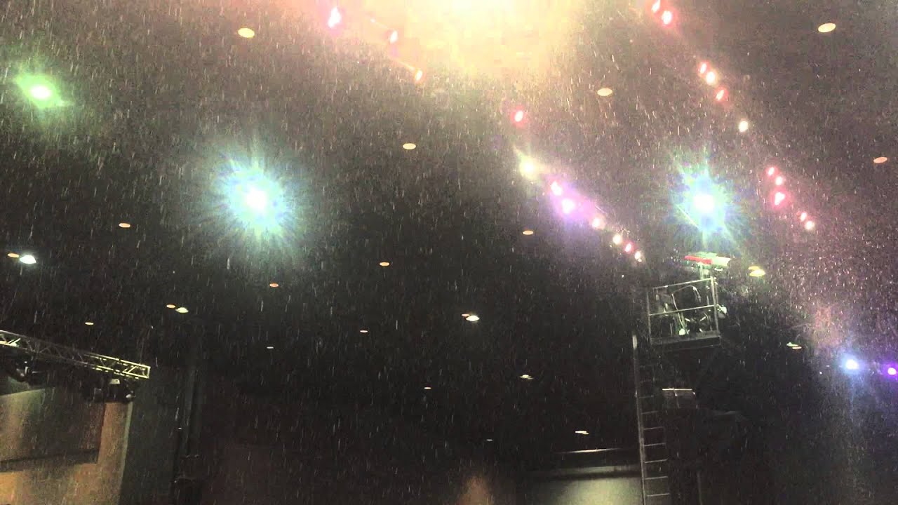 A theater full of of Snow with snow machines for Theme park show