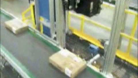 Electric Label Printer Applicator applying labels to varying height cartons