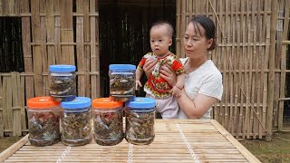 Single mother scoops fish during flood season to make fish sauce and eat snakes and fish