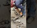 CHECKING BOLTS PARALLELISM IN MECHANICAL WORKSHOP DURING EXCAVATOR'S TRACK CHAIN LINK REPAIR