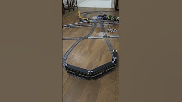 Three LEGO trains crossing on multi-track layout