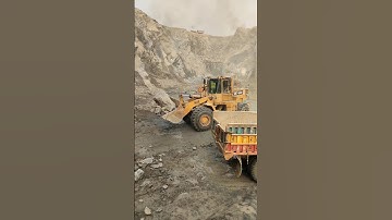 Powerful Rock Loading Performance: Caterpillar 966E Wheel Loader Loading Huge Rocks