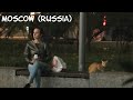 Moscow (Russia): a girl and a cat are waiting for someone near the store / CatDog/ close-ups