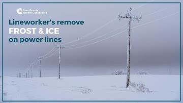 Cass County Electric lineworkers removing frost from power lines