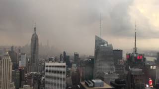 View of downtown manhattan vanishing behind a sheet rain. from the top
rockafella building in new york city.