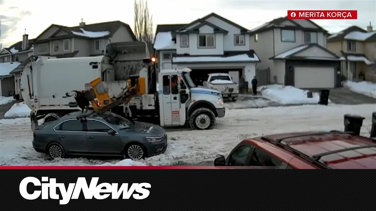 Garbage truck with arm down destroys roof of vehicle in south Edmonton