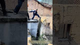 Wall Demolition Attempt: Rural Workers Test Unstable Earthen Structure By Foot Force