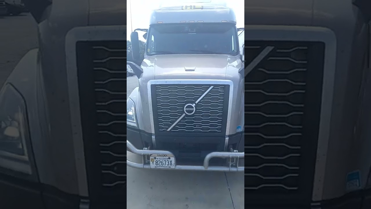 Beautiful lighter Grey Volvo rig visor lights small grill bar big bold yellow / black side stripes
