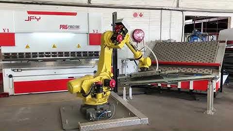 A Fanuc robotic arm transferring sheet metal