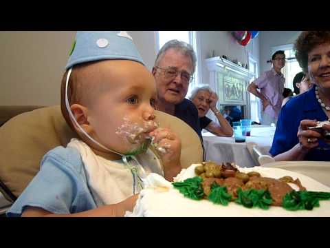 Ethan's first birthday party, blowing out candle. ...