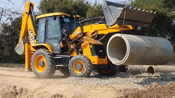 JCB Backhoe Loader Lifting Heavy Culvert Pipe and Installing in Drain- Rural Area Road Construction