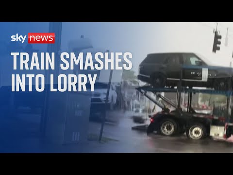 Train smashes into lorry stranded in floods