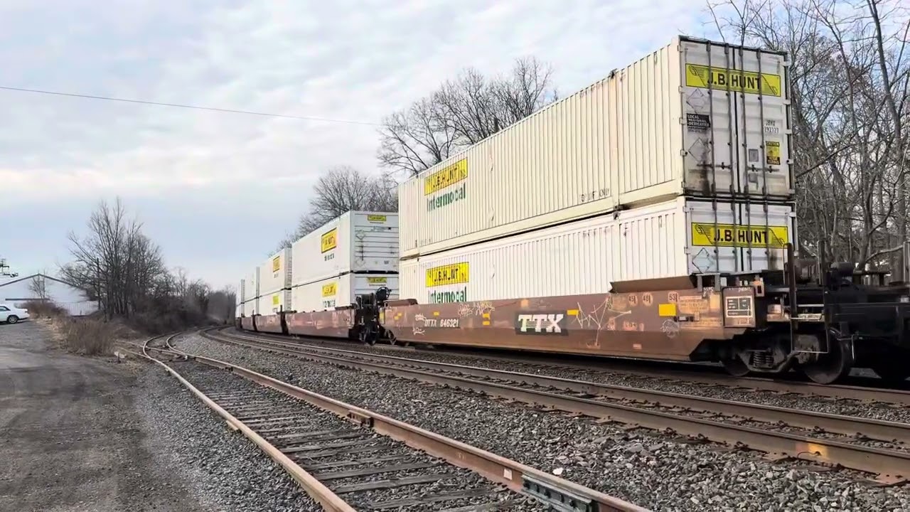 NS 1221 SD70ACe leads NS 28X crawling through Piscataway (Hard to see but nice waving engineer)