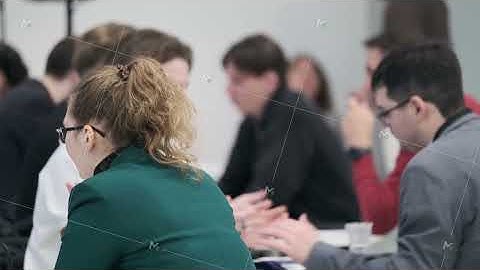 Group of professionals in a meeting discussing ideas around a co