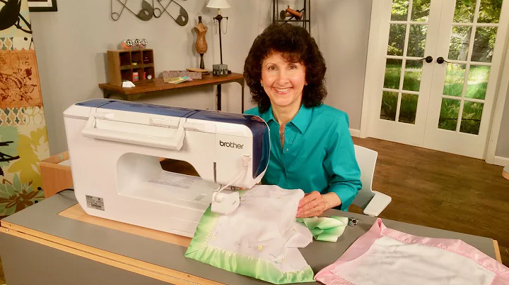 Joanne Banko sews a mitered satin binding on a bab...