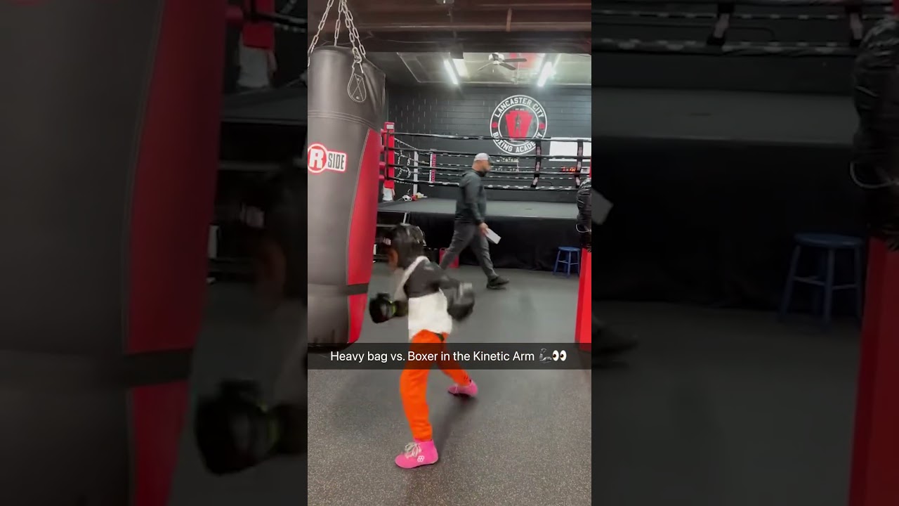Boxer wears the Kinetic Arm during bag work 🥊